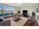 Bright living room featuring a large sofa, big windows, and hardwood floors at 12722 Moonseed Dr, Carmel, IN 46032