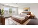 Comfortable main bedroom with a large window, stylish decor and a well-designed wooden platform bed at 12722 Moonseed Dr, Carmel, IN 46032