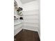 Walk-in pantry with shelving and dark floors at 12722 Moonseed Dr, Carmel, IN 46032