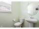 Clean and bright powder room featuring a pedestal sink and neutral decor at 12722 Moonseed Dr, Carmel, IN 46032