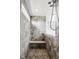 Walk-in shower with gray stone tile, built in bench, and multiple shower heads at 12722 Moonseed Dr, Carmel, IN 46032