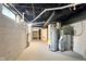 Unfinished basement with painted walls, exposed utilities, and a water heater at 1337 N Concord St, Indianapolis, IN 46222