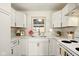 Well-lit kitchen featuring white cabinets, countertops, modern appliances, and a window view at 1337 N Concord St, Indianapolis, IN 46222