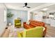 Bright living room with light blue accent wall, modern fan, and open layout to the kitchen at 1337 N Concord St, Indianapolis, IN 46222