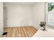A simple, well-lit room with hardwood floors and a large window for natural light at 1337 N Concord St, Indianapolis, IN 46222