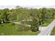 Property aerial showcasing a home with expansive green lawn and bordering foliage at 13765 Howe Rd, Fishers, IN 46038