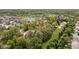An aerial view of a residential area with homes, ponds, and tree-filled surroundings at 13765 Howe Rd, Fishers, IN 46038