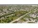 An aerial view of a community with houses, tree-lined streets, and a green park area at 13765 Howe Rd, Fishers, IN 46038