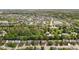 A wide aerial shot highlights a residential area with ponds, green spaces, and a variety of house styles at 13765 Howe Rd, Fishers, IN 46038