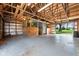 Spacious barn interior featuring wooden beams, horse stalls, and ample natural light at 13765 Howe Rd, Fishers, IN 46038