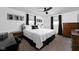 Elegant bedroom with a queen bed, wrought iron headboard, black accents, and carpeted floors at 13765 Howe Rd, Fishers, IN 46038