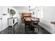 Open-concept dining and living area showcasing sleek flooring, a dining table, and a fireplace, ideal for entertaining at 13765 Howe Rd, Fishers, IN 46038