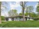Angle view of a brick ranch with an attached two-car garage and well-manicured lawn at 13765 Howe Rd, Fishers, IN 46038