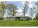 Beautiful home exterior surrounded by green grass and mature trees at 13765 Howe Rd, Fishers, IN 46038