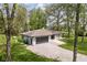 Home exterior showcasing a two-car garage, driveway, and lush, green lawn with trees at 13765 Howe Rd, Fishers, IN 46038