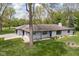 Eye-level exterior showing a home with gray brick, landscaping, and well-maintained lawn at 13765 Howe Rd, Fishers, IN 46038