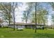 Back exterior view of a charming home with a sunroom and spacious yard at 13765 Howe Rd, Fishers, IN 46038