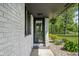 Inviting front entrance with a decorative welcome sign, landscaped garden and a black frame door at 13765 Howe Rd, Fishers, IN 46038