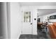 Hallway leading to a dining area and kitchen, highlighted by stylish decor and flooring at 13765 Howe Rd, Fishers, IN 46038