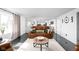 Sunlit living room showcasing a sofa, area rug, and a doorway leading to other parts of the home at 13765 Howe Rd, Fishers, IN 46038