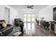Inviting living room with wood floors, leather furniture, office space, and French doors to the outside at 13765 Howe Rd, Fishers, IN 46038