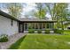 Exterior view of a sunroom with large windows, surrounded by lush greenery at 13765 Howe Rd, Fishers, IN 46038