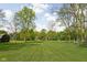 Large grassy yard with mature trees at 13765 Howe Rd, Fishers, IN 46038