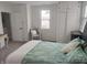 Calm bedroom with a leafy-patterned bedspread, chair and ample storage at 1527 N C N St, Elwood, IN 46036