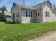 Side view of the home showcasing the well-manicured lawn and residential neighborhood at 1527 N C N St, Elwood, IN 46036