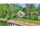 Picturesque view of a two-story home near the water, featuring a deck and a cozy gazebo at 1530 E 75Th St, Indianapolis, IN 46240