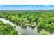 Aerial view of waterfront homes nestled amidst lush greenery along a winding river at 1530 E 75Th St, Indianapolis, IN 46240