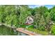 Picturesque view of a two-story home near the water, featuring a deck and a cozy gazebo at 1530 E 75Th St, Indianapolis, IN 46240