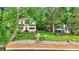 Picturesque view of a two-story home near the water, featuring a deck and a cozy gazebo at 1530 E 75Th St, Indianapolis, IN 46240