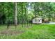 Backyard includes a kennel for dogs and a shed with a tractor nearby on a manicured lawn at 1530 E 75Th St, Indianapolis, IN 46240