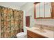 Bathroom featuring a vanity, toilet, and shower with a decorative curtain at 1530 E 75Th St, Indianapolis, IN 46240