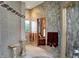 Elegant bathroom features tile walls, mosaic trim, and decorative furniture at 1530 E 75Th St, Indianapolis, IN 46240