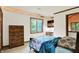 Cozy bedroom with a wooden dresser, natural light and a comfortable bed at 1530 E 75Th St, Indianapolis, IN 46240