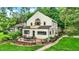 A charming two-story home with a deck that has chairs and a table overlooking a well manicured yard at 1530 E 75Th St, Indianapolis, IN 46240