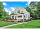 A charming two-story home with a deck that has chairs and a table overlooking a well manicured yard at 1530 E 75Th St, Indianapolis, IN 46240