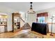 Foyer with hardwood floors, glass paneled doors, display cabinet and staircase at 1530 E 75Th St, Indianapolis, IN 46240