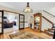 Foyer with hardwood floors, glass paneled doors, display cabinet and staircase at 1530 E 75Th St, Indianapolis, IN 46240