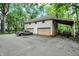 Three car garage with two garage doors, a covered awning, and a large parking area at 1530 E 75Th St, Indianapolis, IN 46240