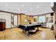 Bright living room with hardwood floors, wet bar, and billiard table covered with black tarp at 1530 E 75Th St, Indianapolis, IN 46240