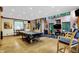 Open-concept living room features hardwood floors and multiple windows overlooking the greenery at 1530 E 75Th St, Indianapolis, IN 46240