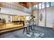 Open-concept living and dining area with glass table and view of the billiard room at 1530 E 75Th St, Indianapolis, IN 46240
