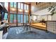 Bright living room with a fireplace, vaulted wood ceiling, and walls of windows at 1530 E 75Th St, Indianapolis, IN 46240