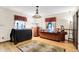 Bright living room featuring hardwood floors, decorative windows, and a unique display cabinet at 1530 E 75Th St, Indianapolis, IN 46240