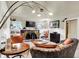 Cozy living room featuring an ornate fireplace, large windows, and comfortable seating at 1530 E 75Th St, Indianapolis, IN 46240