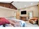 Spacious main bedroom with en suite bathroom access and entertainment center at 1530 E 75Th St, Indianapolis, IN 46240