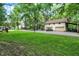 Exterior view of a large manicured lawn and the multiple car garage and accessory buildings at 1530 E 75Th St, Indianapolis, IN 46240